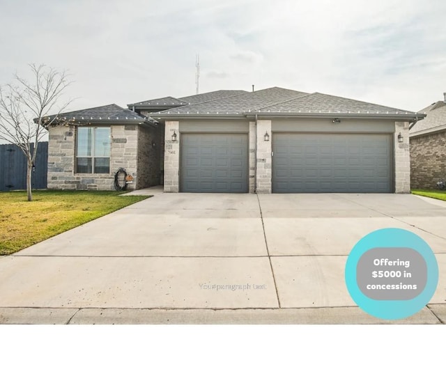 view of front of house with a garage and a front yard