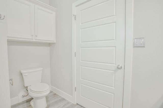 bathroom featuring toilet and hardwood / wood-style floors