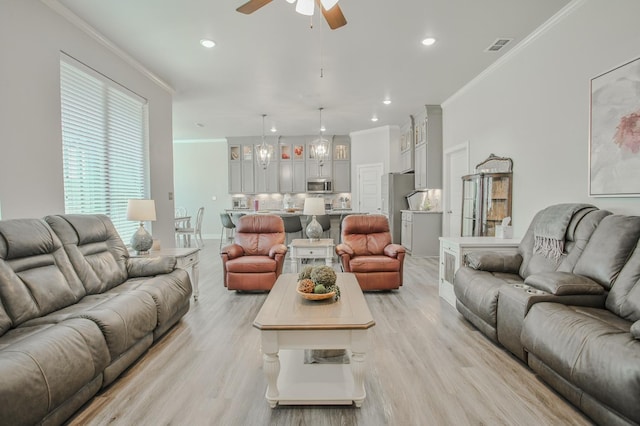 living room featuring crown molding, ceiling fan, and light wood-type flooring