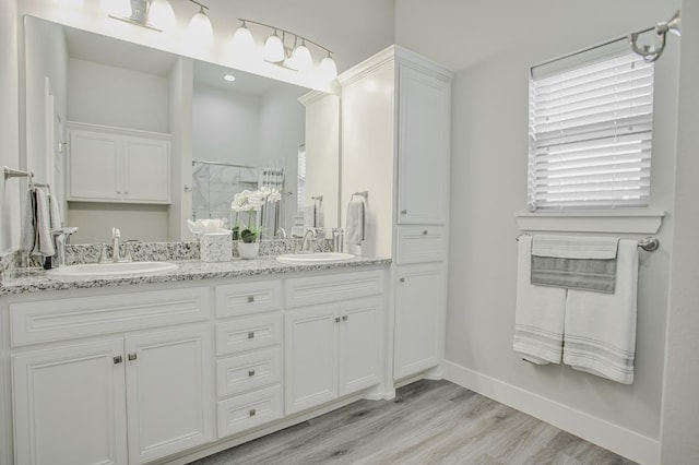 bathroom with a shower with door, wood-type flooring, and vanity