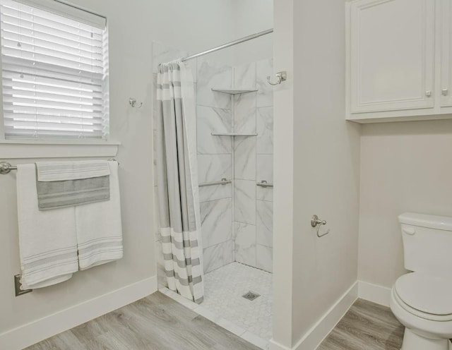 bathroom featuring a shower with curtain, wood-type flooring, and toilet