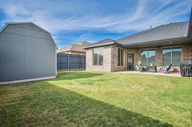 rear view of house featuring a storage shed, a lawn, and a patio