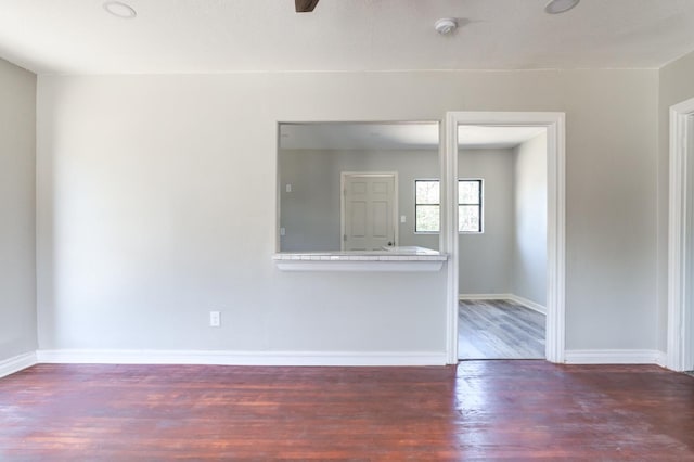 empty room featuring dark hardwood / wood-style flooring