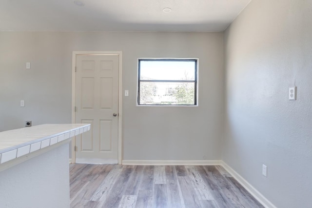 unfurnished room with light hardwood / wood-style flooring