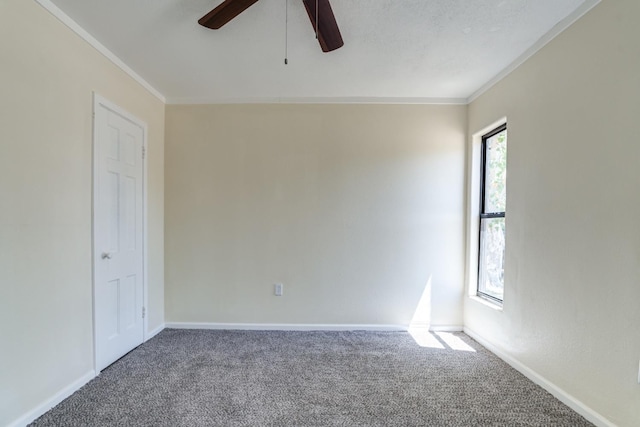 unfurnished room with crown molding, carpet flooring, and ceiling fan