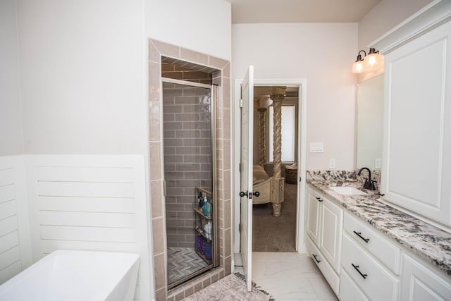 full bath with a shower stall, a freestanding bath, vanity, ensuite bath, and marble finish floor