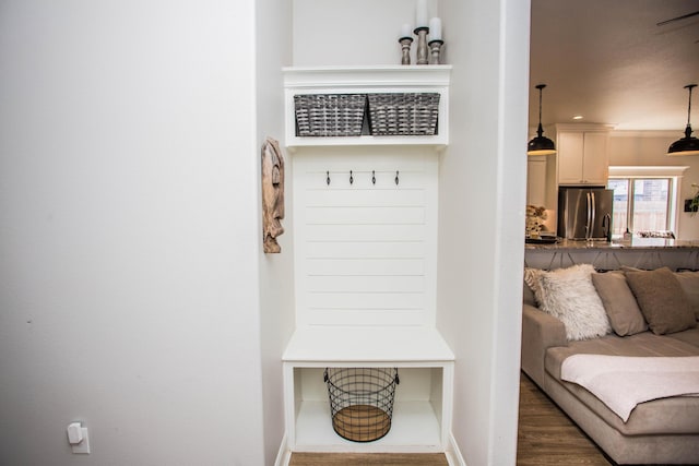 mudroom with baseboards and wood finished floors