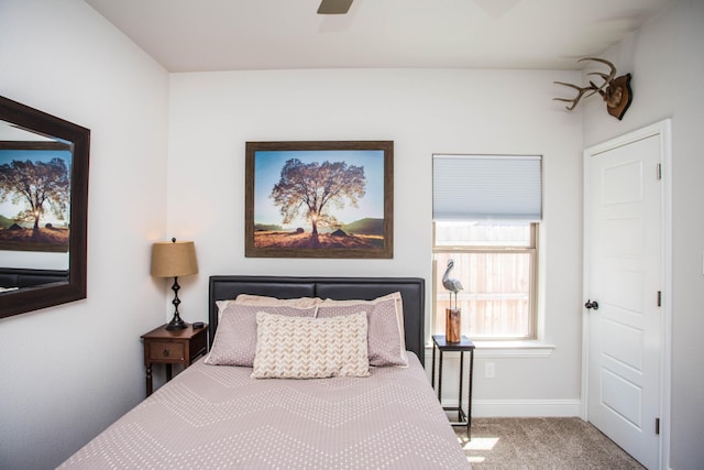 carpeted bedroom with ceiling fan and baseboards