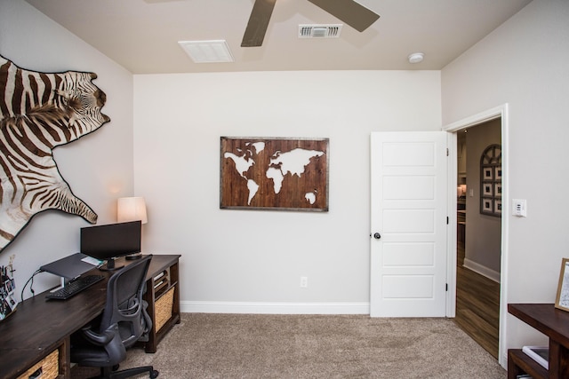 office space with carpet flooring, visible vents, ceiling fan, and baseboards