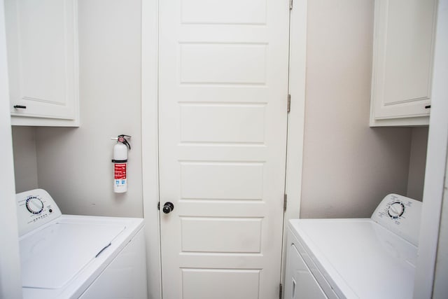 laundry area featuring washer and dryer and cabinet space