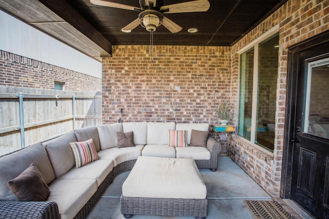 view of patio / terrace with fence, a ceiling fan, and an outdoor living space