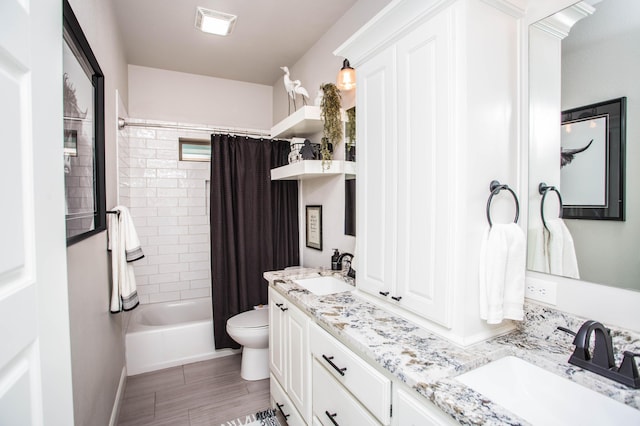 full bath with shower / bath combo with shower curtain, toilet, double vanity, and a sink