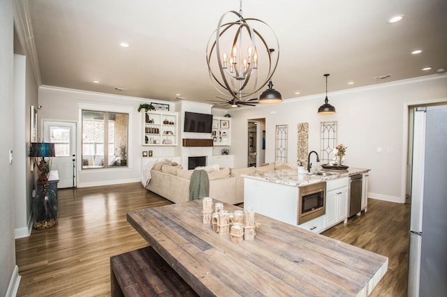 dining room with crown molding, a fireplace, and baseboards