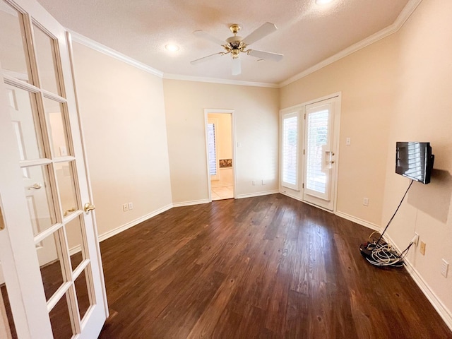 unfurnished room featuring crown molding, dark hardwood / wood-style floors, ceiling fan, and french doors