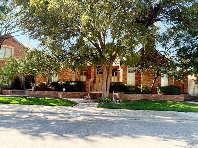 obstructed view of property featuring a front yard