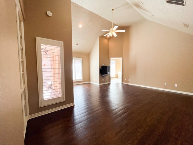 unfurnished living room featuring ceiling fan, dark hardwood / wood-style floors, and high vaulted ceiling