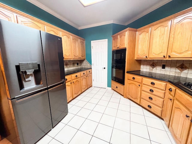 kitchen with tasteful backsplash, black microwave, light tile patterned floors, ornamental molding, and stainless steel fridge