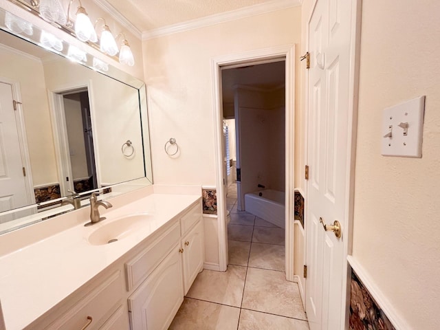 bathroom featuring vanity, tile patterned flooring, a bathtub, and ornamental molding