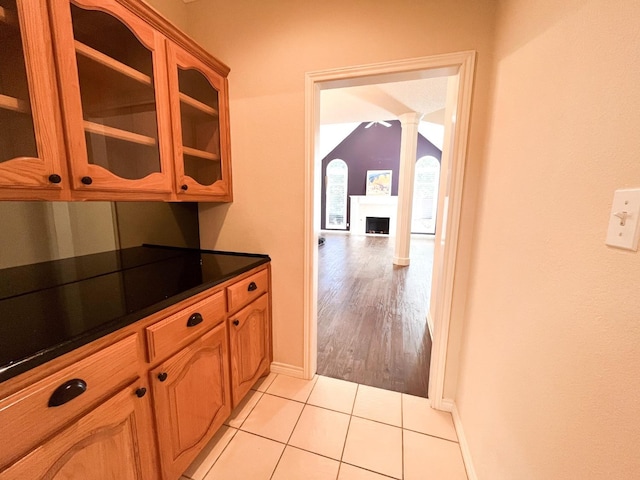 kitchen featuring light tile patterned floors and ornate columns