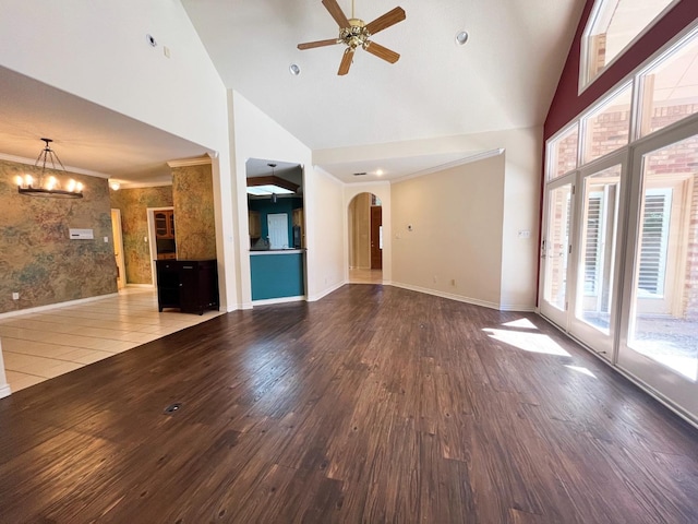 unfurnished living room featuring crown molding, ceiling fan with notable chandelier, high vaulted ceiling, and hardwood / wood-style flooring