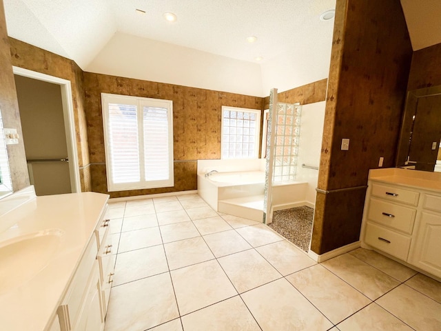 bathroom with tile patterned floors, a tub, and a healthy amount of sunlight