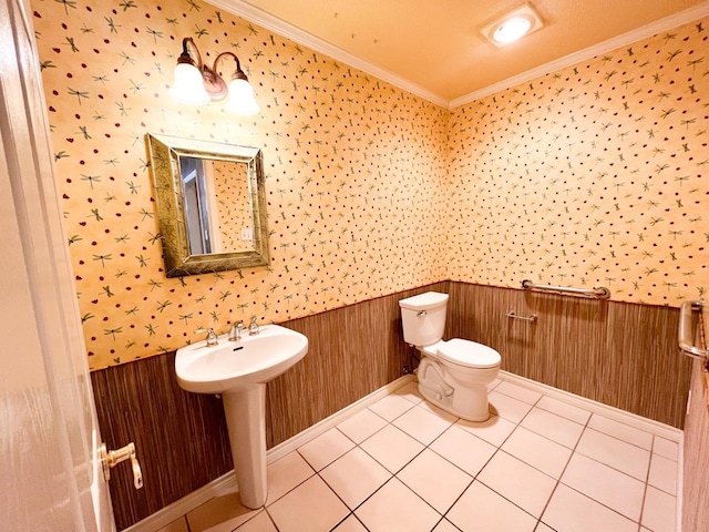 bathroom featuring tile patterned floors, ornamental molding, and toilet