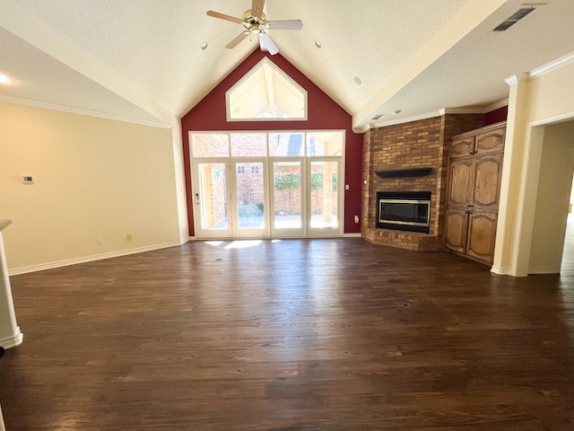 unfurnished living room with a brick fireplace, dark hardwood / wood-style floors, a textured ceiling, and ceiling fan