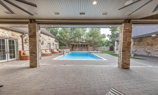 view of swimming pool featuring a diving board, a patio, ceiling fan, and french doors