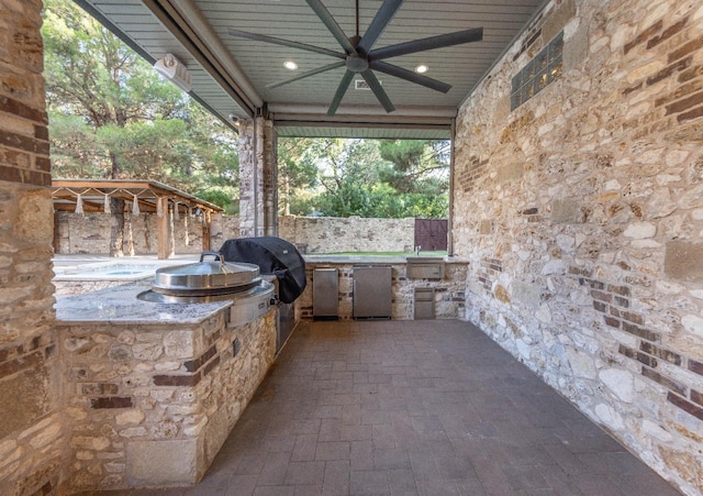 view of patio / terrace featuring ceiling fan, area for grilling, and a grill