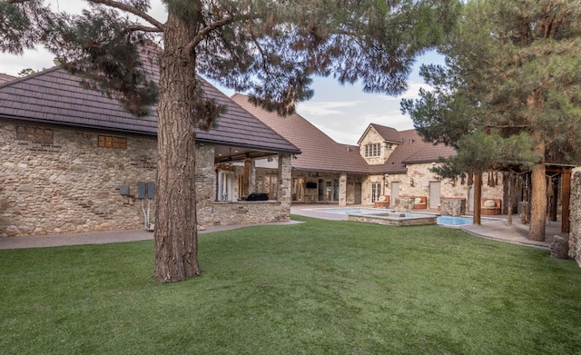 rear view of property featuring a lawn