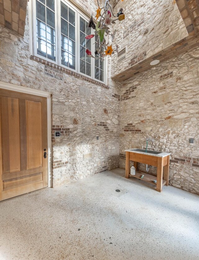 miscellaneous room with a towering ceiling