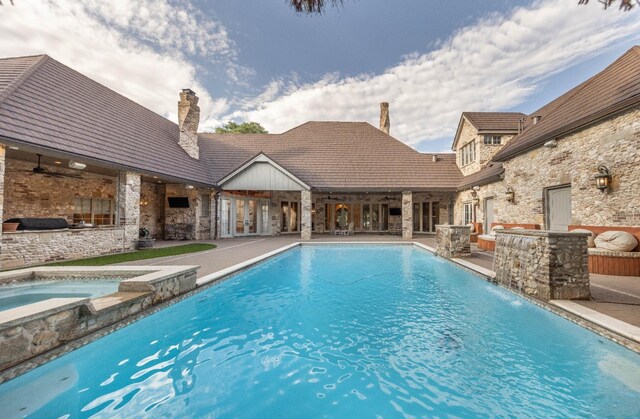 view of pool with pool water feature, a patio, ceiling fan, and an in ground hot tub