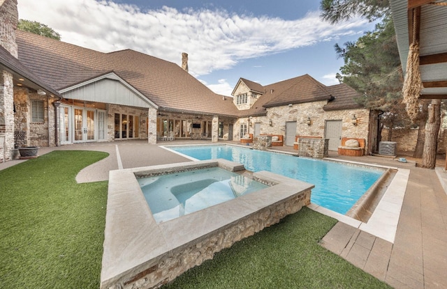 view of swimming pool with a yard, a patio area, and an in ground hot tub