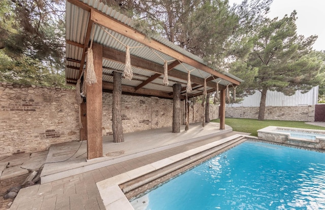 view of swimming pool featuring an in ground hot tub and a patio area