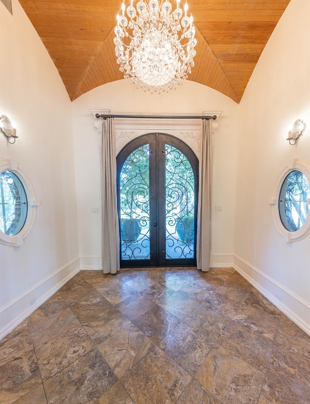 foyer featuring french doors, high vaulted ceiling, wood ceiling, and an inviting chandelier