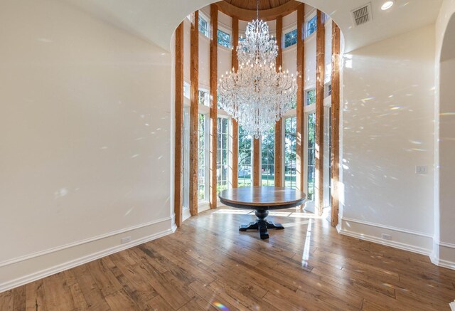 interior details featuring an inviting chandelier and hardwood / wood-style flooring