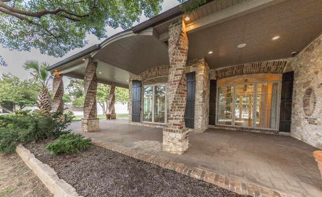 view of exterior entry featuring covered porch