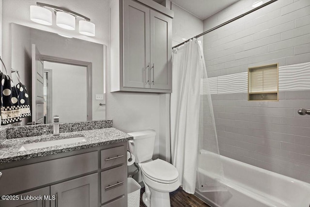902 N Fulton Ave, Lubbock, TX 79416 - full bathroom with wood finished floors, toilet, shower / tub combo, and vanity