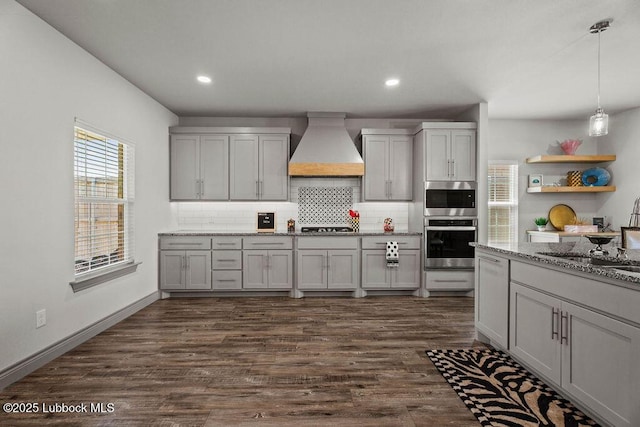902 N Fulton Ave, Lubbock, TX 79416 - kitchen with custom range hood, tasteful backsplash, light stone countertops, dark wood-style floors, and recessed lighting