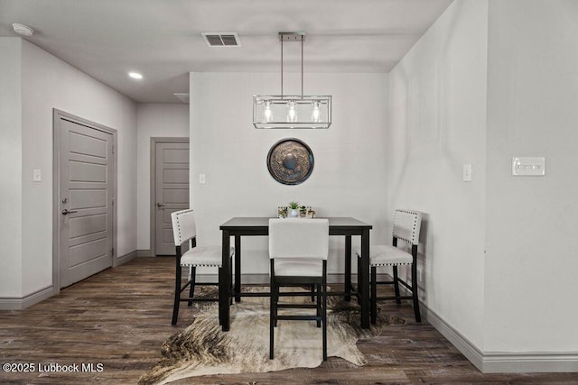 902 N Fulton Ave, Lubbock, TX 79416 - dining space with dark wood-style floors, baseboards, and a chandelier