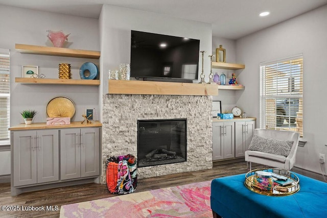 902 N Fulton Ave, Lubbock, TX 79416 - living room featuring dark wood-style floors, a stone fireplace, and recessed lighting