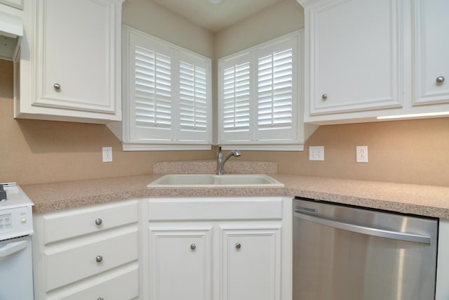 9808 Huron Ave, Lubbock, TX 79424 - kitchen featuring stainless steel dishwasher, white cabinetry, and light countertops