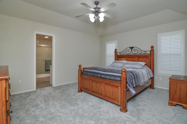 9808 Huron Ave, Lubbock, TX 79424 - bedroom with light colored carpet, ensuite bathroom, and a ceiling fan