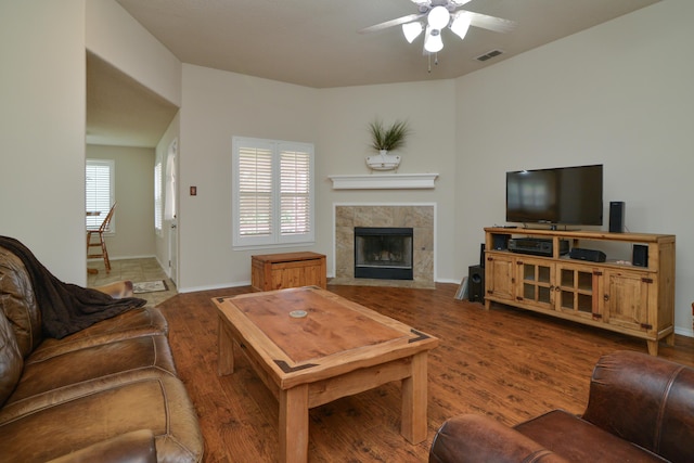 9808 Huron Ave, Lubbock, TX 79424 - living area with ceiling fan, a tiled fireplace, and wood finished floors