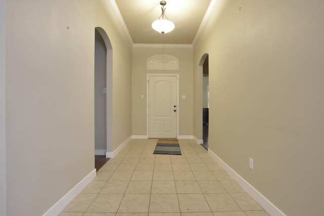 doorway featuring crown molding and light tile patterned floors