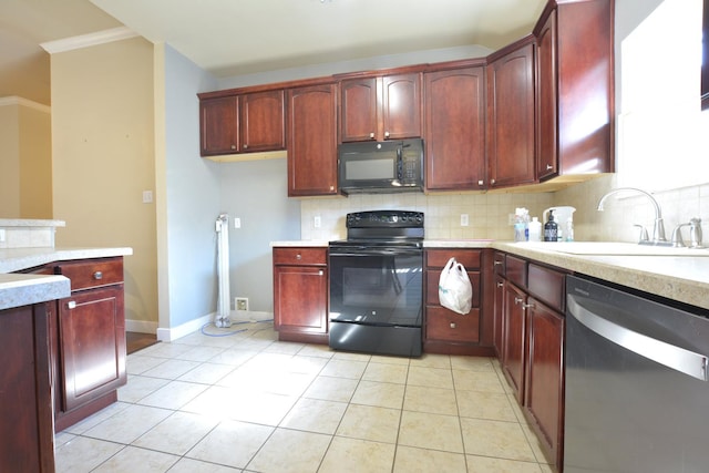 kitchen featuring tasteful backsplash, sink, light tile patterned floors, and black appliances