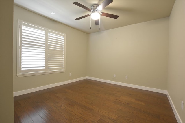 unfurnished room featuring dark wood-type flooring and ceiling fan