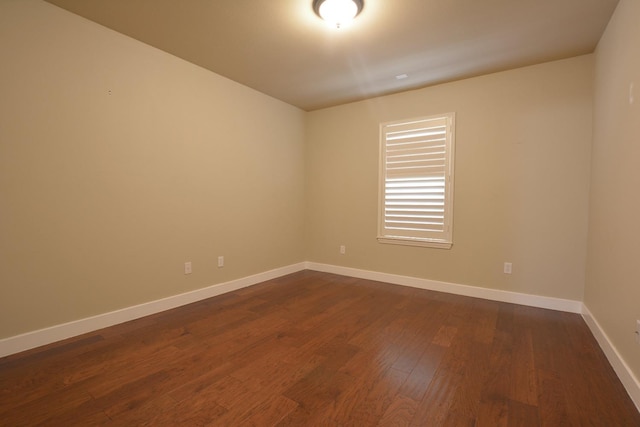 unfurnished room with dark hardwood / wood-style floors