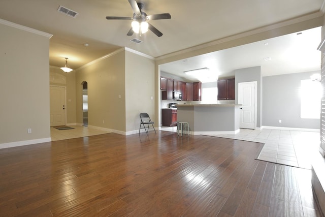 unfurnished living room with ornamental molding, ceiling fan, and light wood-type flooring