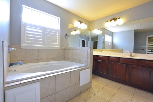 bathroom with vanity, tiled tub, and tile patterned floors